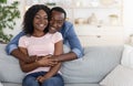 Cheerful african man hugging his smiling wife from behind Royalty Free Stock Photo