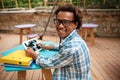 Cheerful african young man using tablet in outdoor cafe Royalty Free Stock Photo