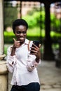 Cheerful beautiful afro american female making selfie phone with thumbs up for publishing in social networks outdoors in campus