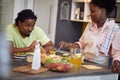 Cheerful Afro-American man and woman having diner Royalty Free Stock Photo