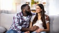 Cheerful Afro-American man stroking his pregnant wife belly, loving couple Royalty Free Stock Photo