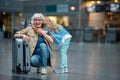 Cheerful aged lady and little girl are posing with smile