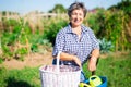 Cheerful aged woman ready to work in home garden