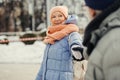 Pleased aged lady smiling while husband holding her hand