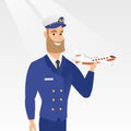 Cheerful airline pilot with the model of airplane. Royalty Free Stock Photo
