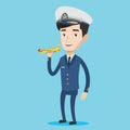 Cheerful airline pilot with model airplane. Royalty Free Stock Photo