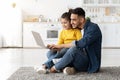 Cheerful Arab Dad And Little Daughter Shopping Online With Laptop At Home Royalty Free Stock Photo