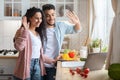 Cheerful Arab Food Bloggers Couple Recording Video For Their Blog In Kitchen