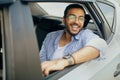 Cheerful arab guy passenger enjoying car ride