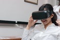 Cheerful Asian business woman wearing virtual reality glasses in office Royalty Free Stock Photo