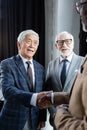 cheerful asian businessman shaking hands with Royalty Free Stock Photo