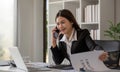 Cheerful Asian businesswoman talking on the phone working in modern office Happy Asian businesswoman company manager Royalty Free Stock Photo