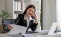 Cheerful Asian businesswoman talking on the phone working in modern office Happy Asian businesswoman company manager Royalty Free Stock Photo