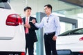 Asian Car Salesman selling auto to customer Royalty Free Stock Photo