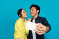 Cheerful asian couple in casual make selfie at smartphone, rejoicing date Royalty Free Stock Photo