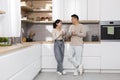 Cheerful asian couple enjoying morning coffee at home Royalty Free Stock Photo