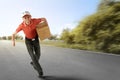 Cheerful asian courier running with holding the package