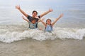 Cheerful Asian father, little boy and young girl kid enjoy playing and lying on tropical sea beach. Happy family having fun in Royalty Free Stock Photo