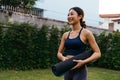 Happy Asian yoga trainer in garden yard