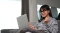 Asian girl student using laptop computer for studying online at home. Royalty Free Stock Photo