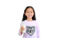 Cheerful asian little child girl drinking milk from glass bottle isolated on white background Royalty Free Stock Photo