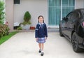 Cheerful asian little child girl in school uniform walking leave the house go to school at morning