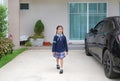 Cheerful asian little child girl in school uniform walking leave the house go to school at morning