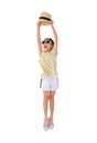 Cheerful asian little child girl wearing sunglasses and lift up straw hat jumping on white background isolated. Summer and fashion Royalty Free Stock Photo