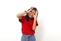 Cheerful asian little girl standing with looking through binoculars gesture. Isolated on white Royalty Free Stock Photo