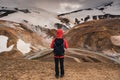 Asian man standing on geothermal area and volcanic mountain on summer in highlands at Kerlingarfjoll, Iceland