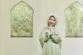 Cheerful asian muslim girl wearing hijab praying Royalty Free Stock Photo