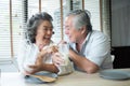 Asian senior couple in love drinking milk