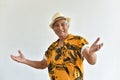 Cheerful asian senior old man, Confident and smiling elderly people with welcome gesture in colorful hawaii shirt.