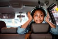 Cheerful Asian Teenage Girl with Headphones Enjoy Listening Music in the Car