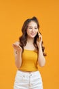 Cheerful Asian teenage girl laughing while talking on cellphone Royalty Free Stock Photo