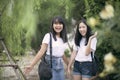 Cheerful asian teenager laughing in green park