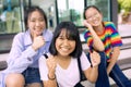 Cheerful asian teenager at school bulding