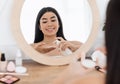 Cheerful asian woman cleaning her face, using cotton pads Royalty Free Stock Photo