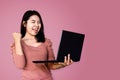 Cheerful Asian woman holding computer celebrating for her success online business concept Royalty Free Stock Photo