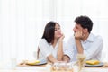 Cheerful asian young man and woman having sitting lunch and talking together Royalty Free Stock Photo