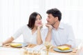 Cheerful asian young man and woman having sitting lunch and talking together at kitchen Royalty Free Stock Photo