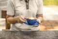 Cheerful asian young woman drinking warm coffee or tea enjoying it while sitting in cafe Royalty Free Stock Photo