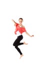 Cheerful, athletic girl jumping and looking into the camera. Isolated.