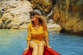 Cheerful attractive adult woman smile and enjoy canoe jayaj trip journey on a blue river in a canyon. Tourist and outdoor new Royalty Free Stock Photo