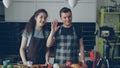 Cheerful attractive couple recording video food vlog about healthy cooking on digital camera in the kitchen at home Royalty Free Stock Photo