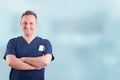 Cheerful attractive medic standing with folded arms and posing Royalty Free Stock Photo