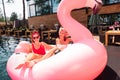 Cheerful attractive models having fun in the pool