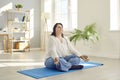 Cheerful attractive overweight young woman doing yoga at home Royalty Free Stock Photo