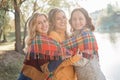 Cheerful attractive three young women best friends having fun together outside. Royalty Free Stock Photo