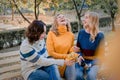 Cheerful attractive three young women best friends having fun together outside.